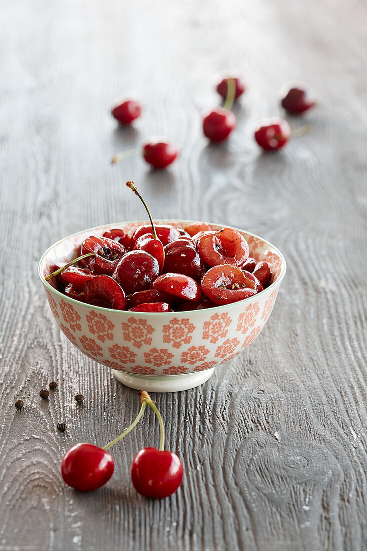 A bowl of cherries with pepper