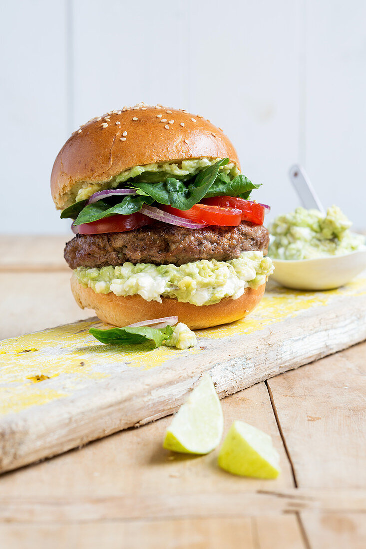 A homemade burger with beef and guacamole