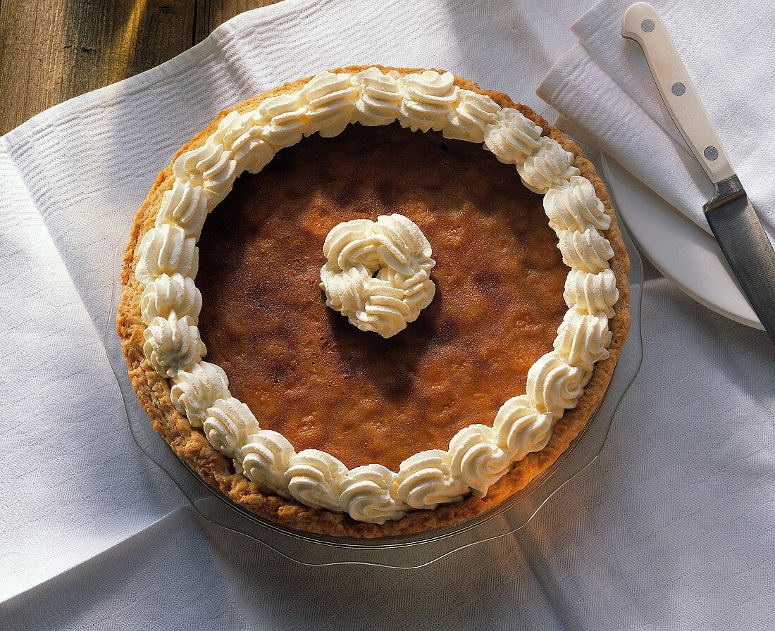 A pumpkin pie decorated with cream edge