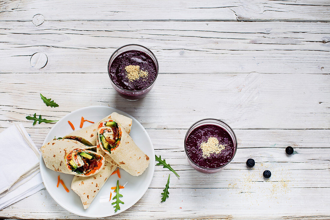 Healthy vegetable wraps and a blueberry smoothie bowl