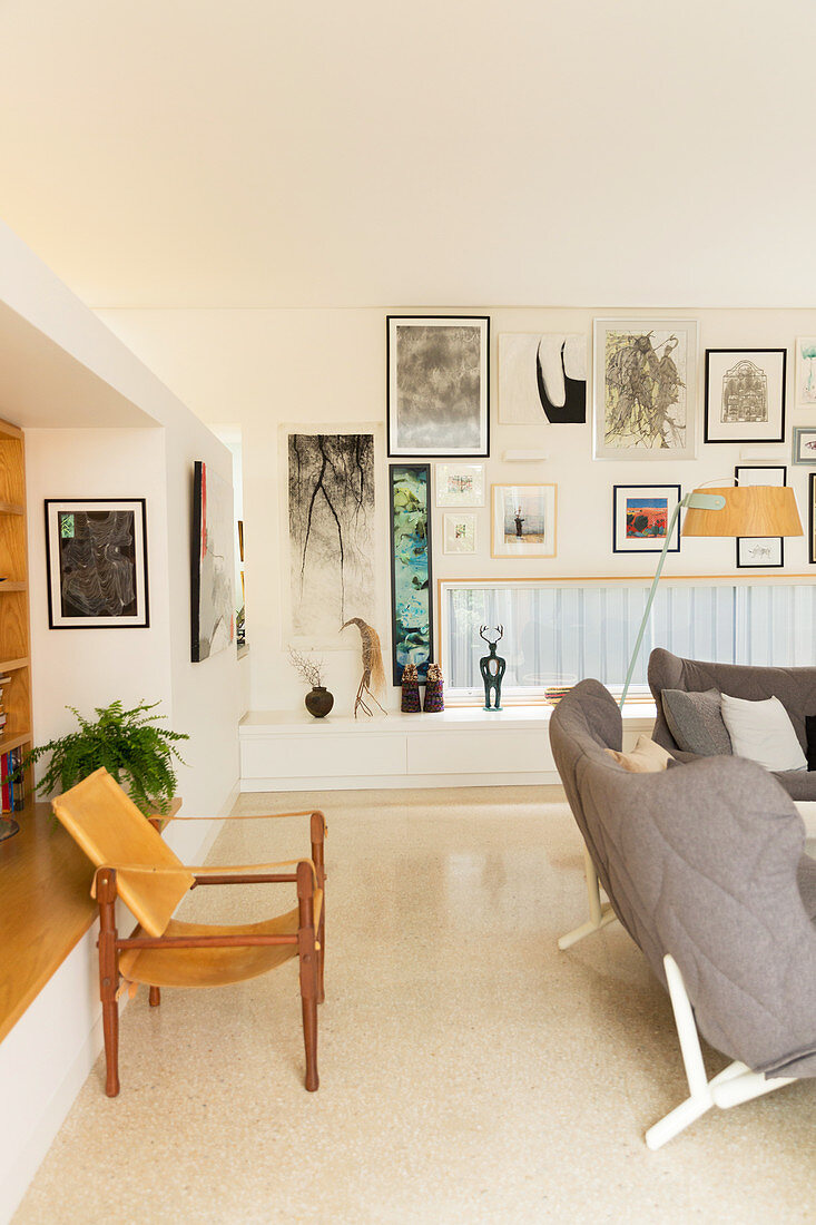 Designer chair in the living room with horizontal window and picture wall