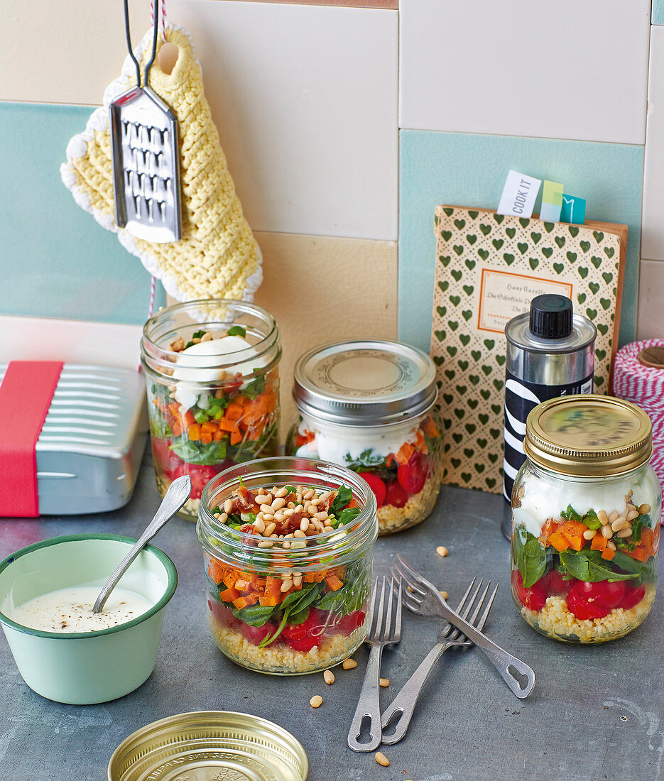 Layered vegetable salad with dates and yoghurt in jars