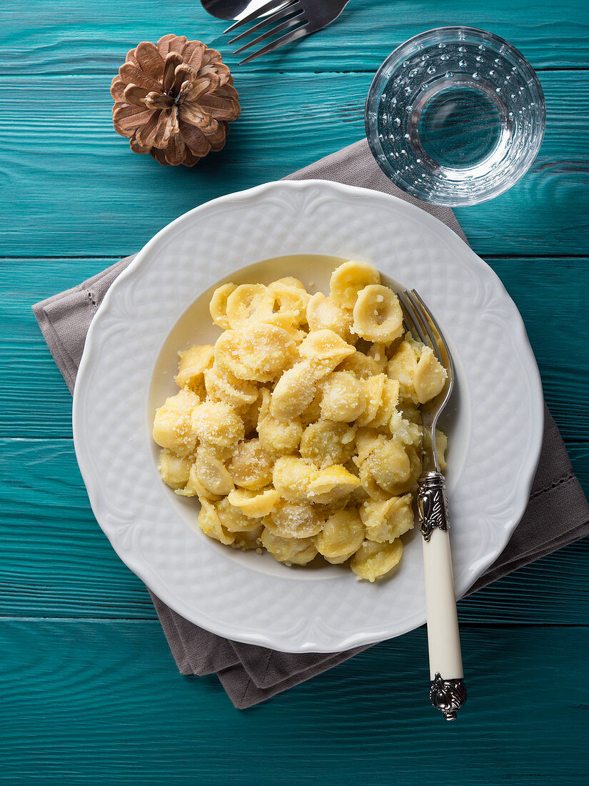 Traditional Italian pasta Orecchiette with spiced cauliflower and grated Parmesan cheese