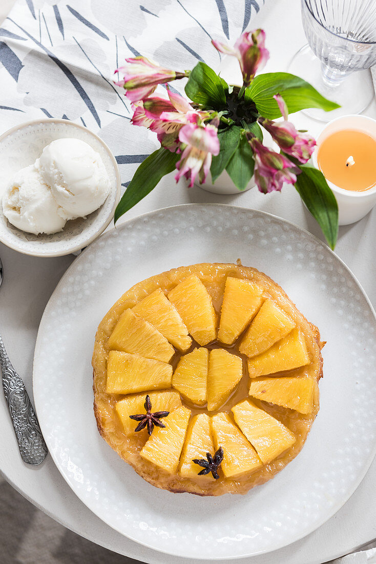 A pineapple tart with star anise and vanilla ice cream