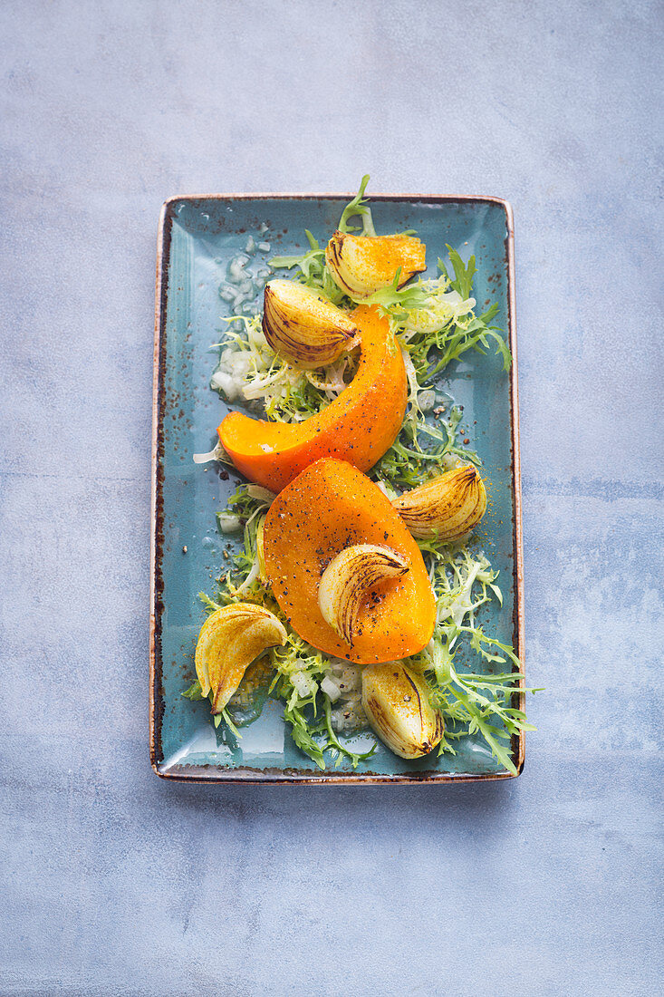 Baked Hokkaido pumpkin on frisée lettuce