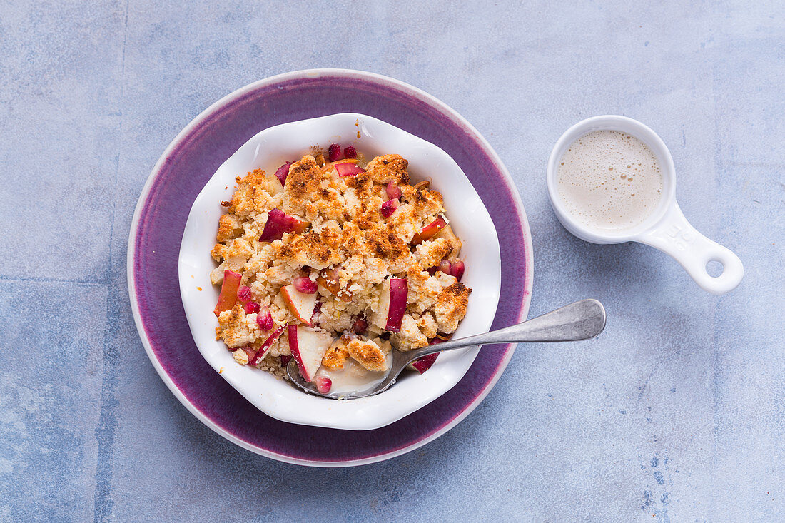 Pear and apple crumble with coconut and pomegranate seeds