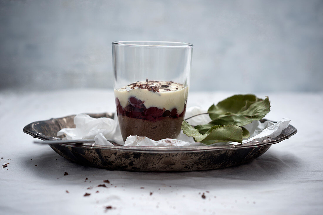 Vegan chocolate semolina pudding, sour cherries and soya yoghurt in a glass