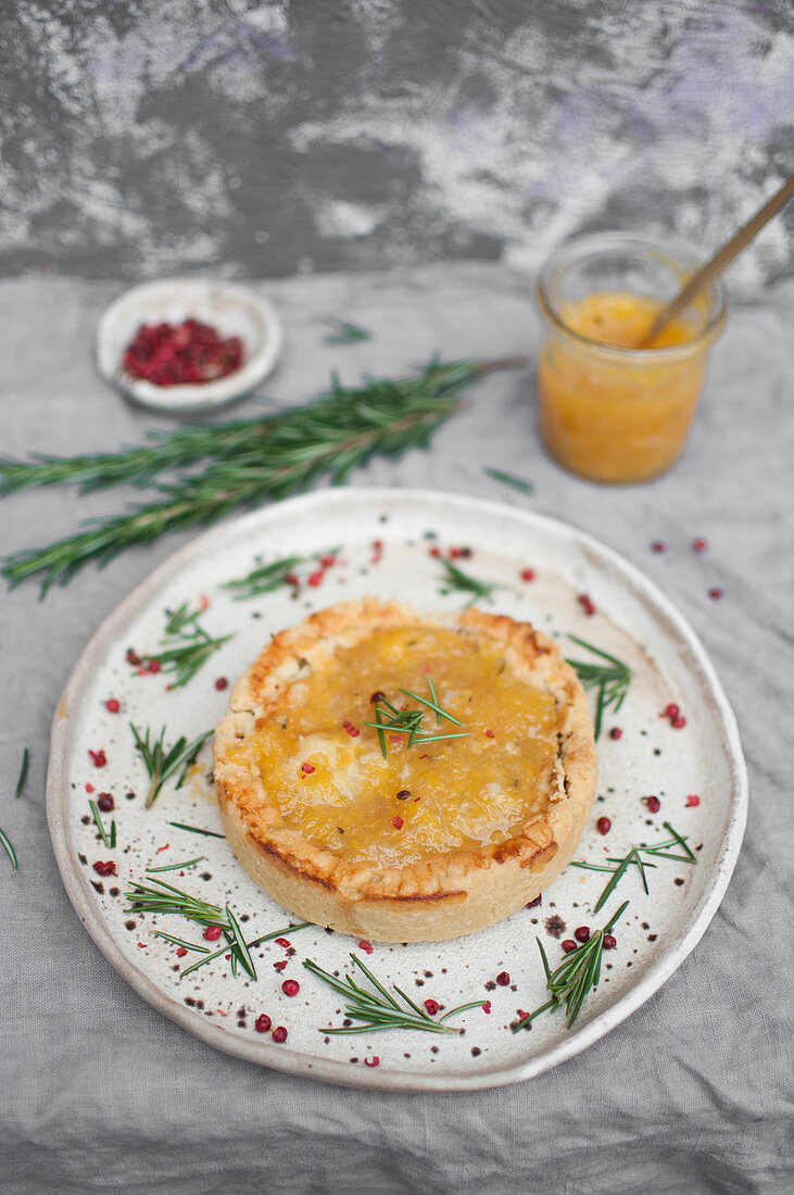 Christmas duck shortcrust pie topped with orange-rosemary jam and rose pepper