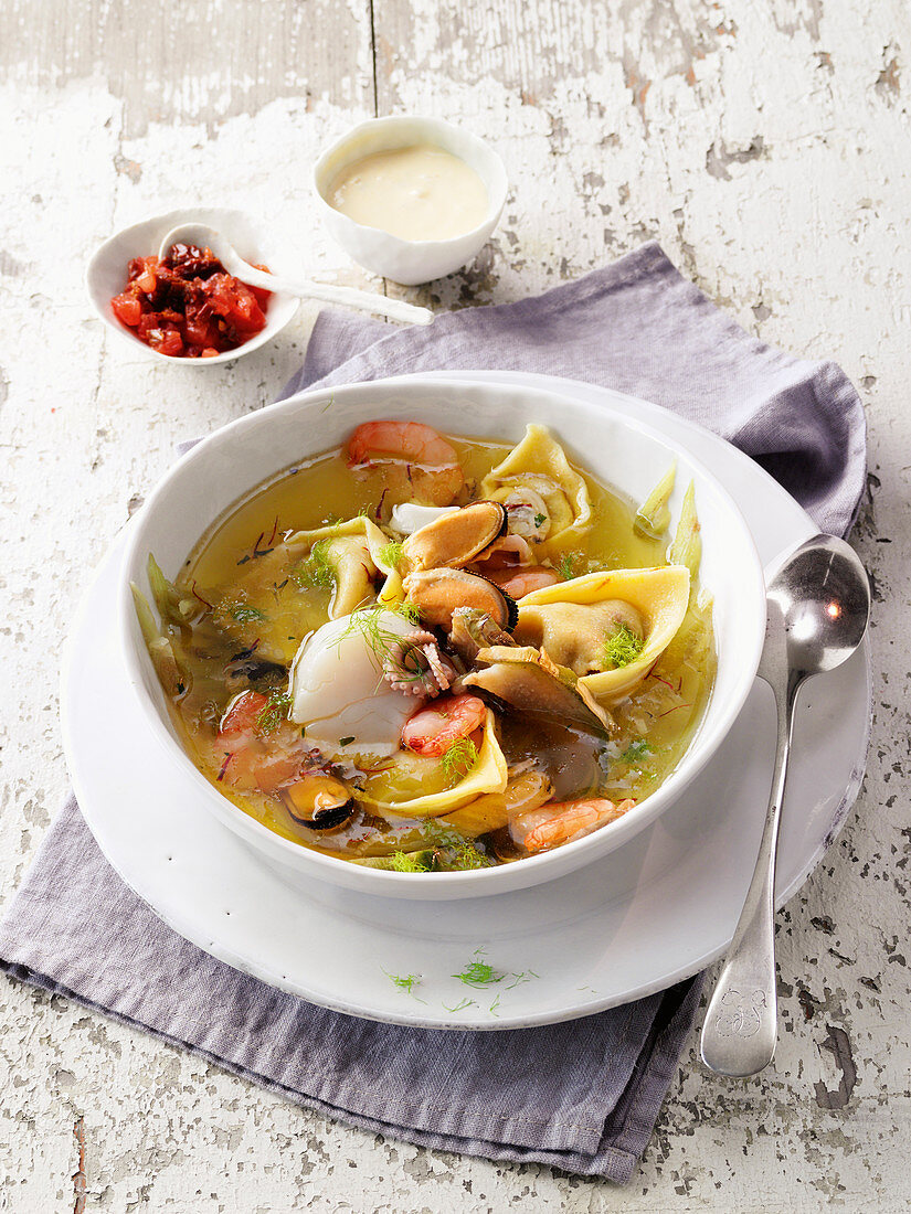 Seafood in an artichoke broth with tortellini and aioli