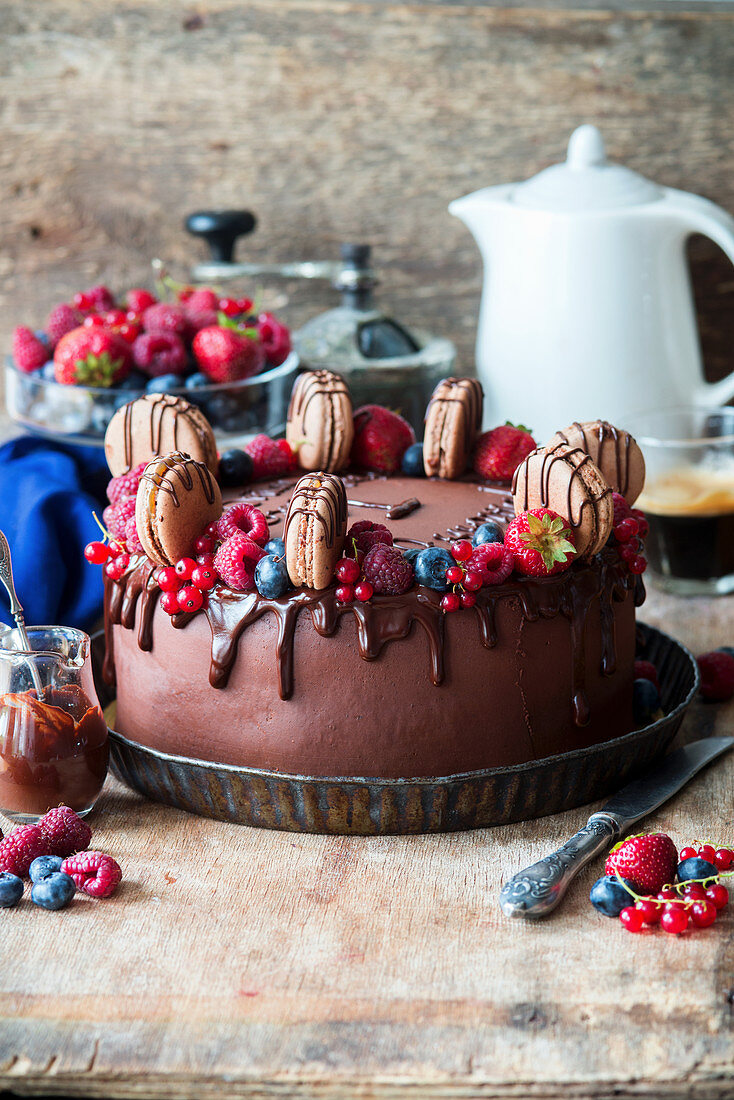 Chocolate cake with berries and chocolate macarons