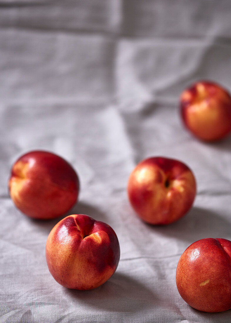 Nectarines on a white tablecloth