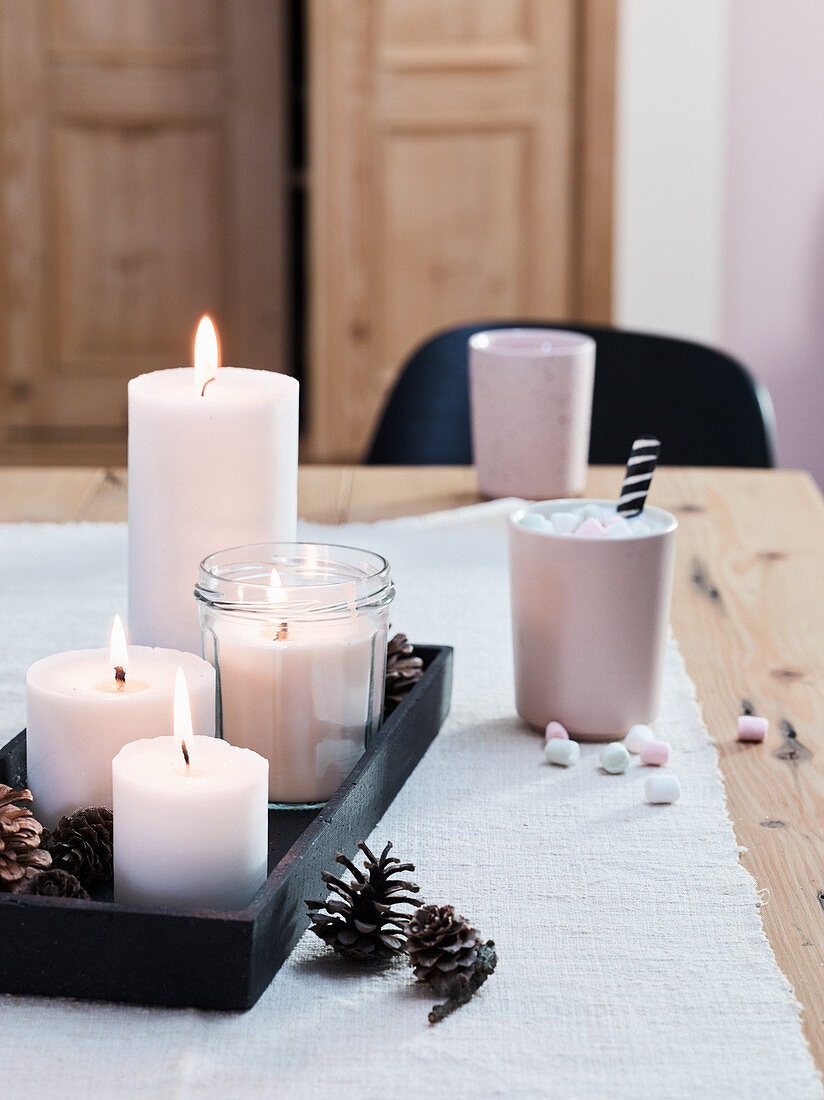 Homemade candles on a wooden tray