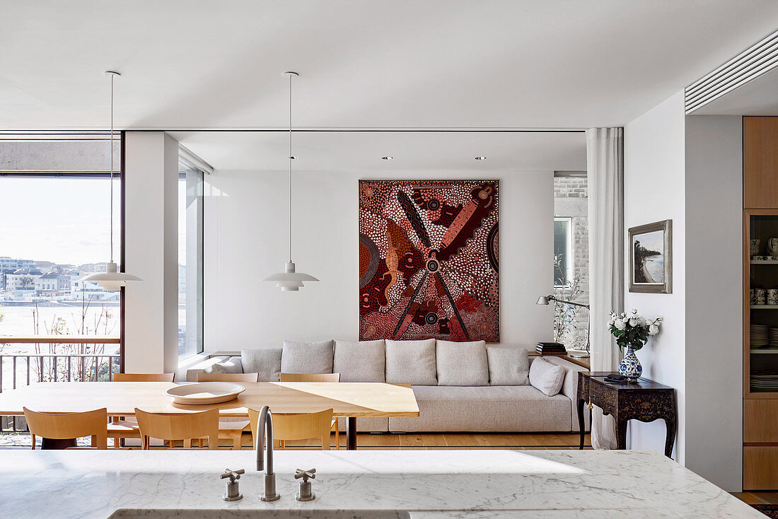 View over Carrara marble top to dining table and upholstered sofa