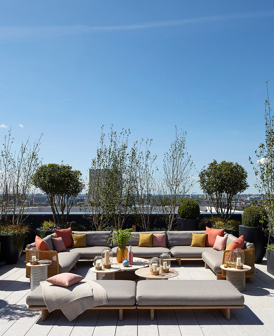 Große Sofalandschaft auf bepflanzter Dachterrasse mit Blick über London