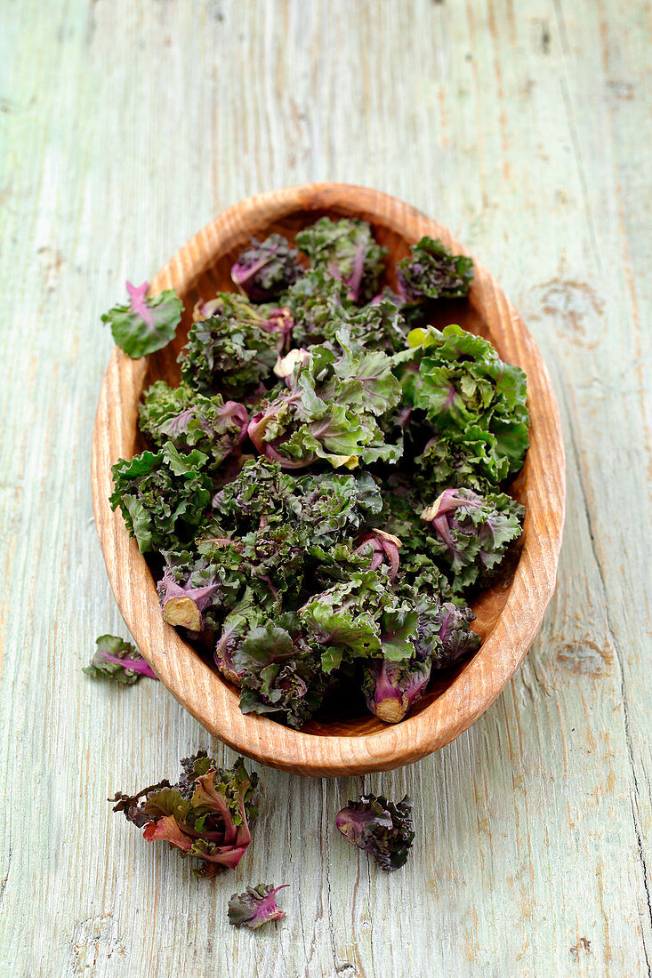 Flower sprouts (a cross between Brussels sprouts and kale) in a wooden bowl