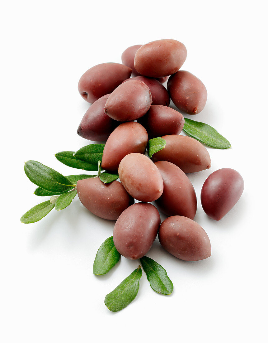 A pile of fresh olives on a white surface