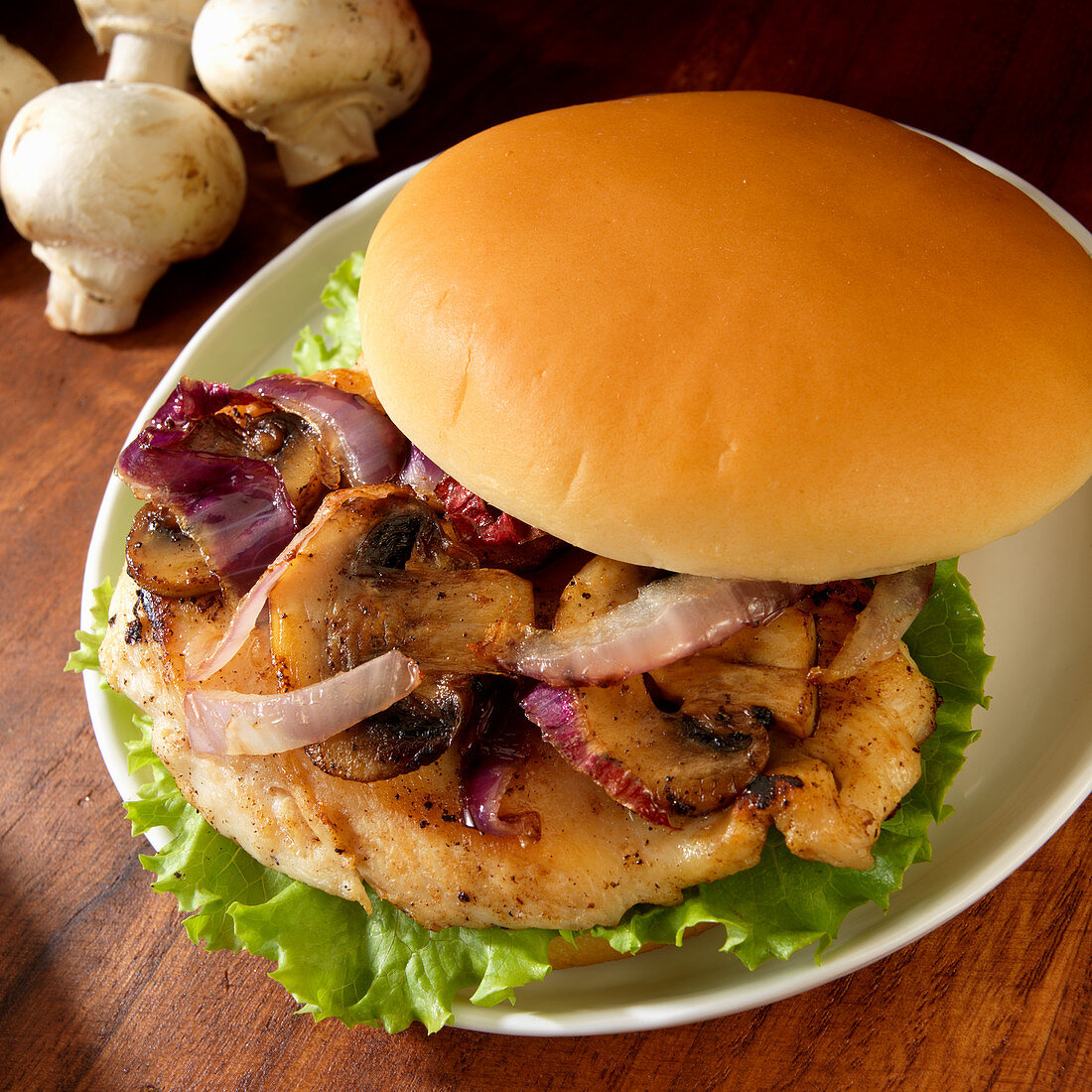 Grilled chicken sandwich with grilled mushrooms and onions