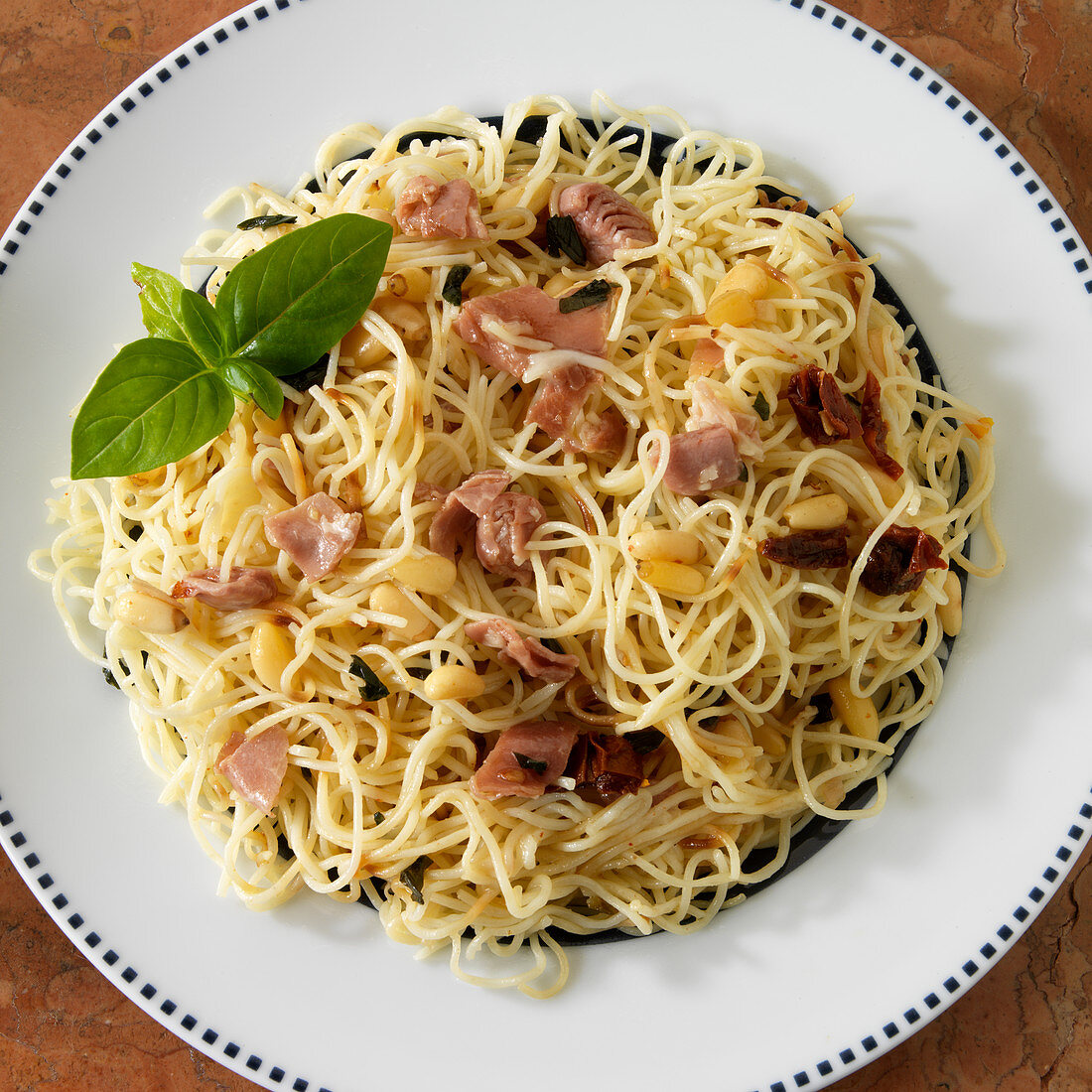 Angel hair pasta with prosciutto, pine nuts, sun dried tomato, basil