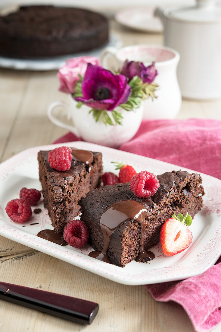 Chocolate beetroot cake with chocolate sauce and berries