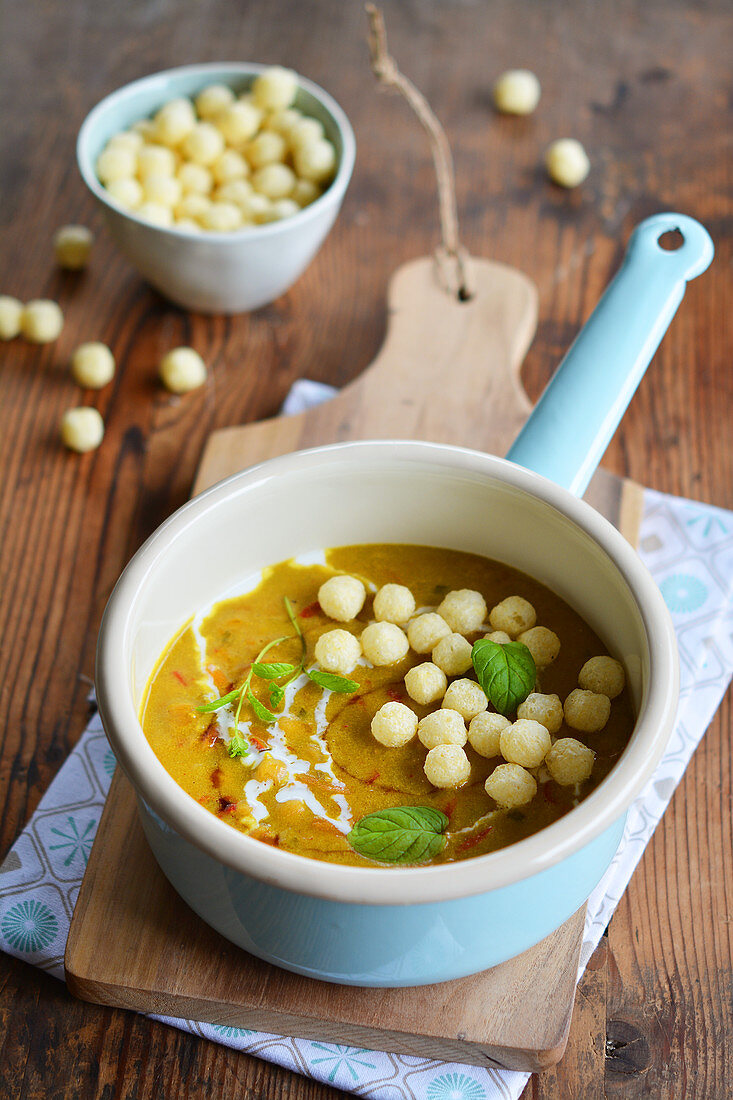 Currysuppe mit Hirsebällchen im Emailletopf