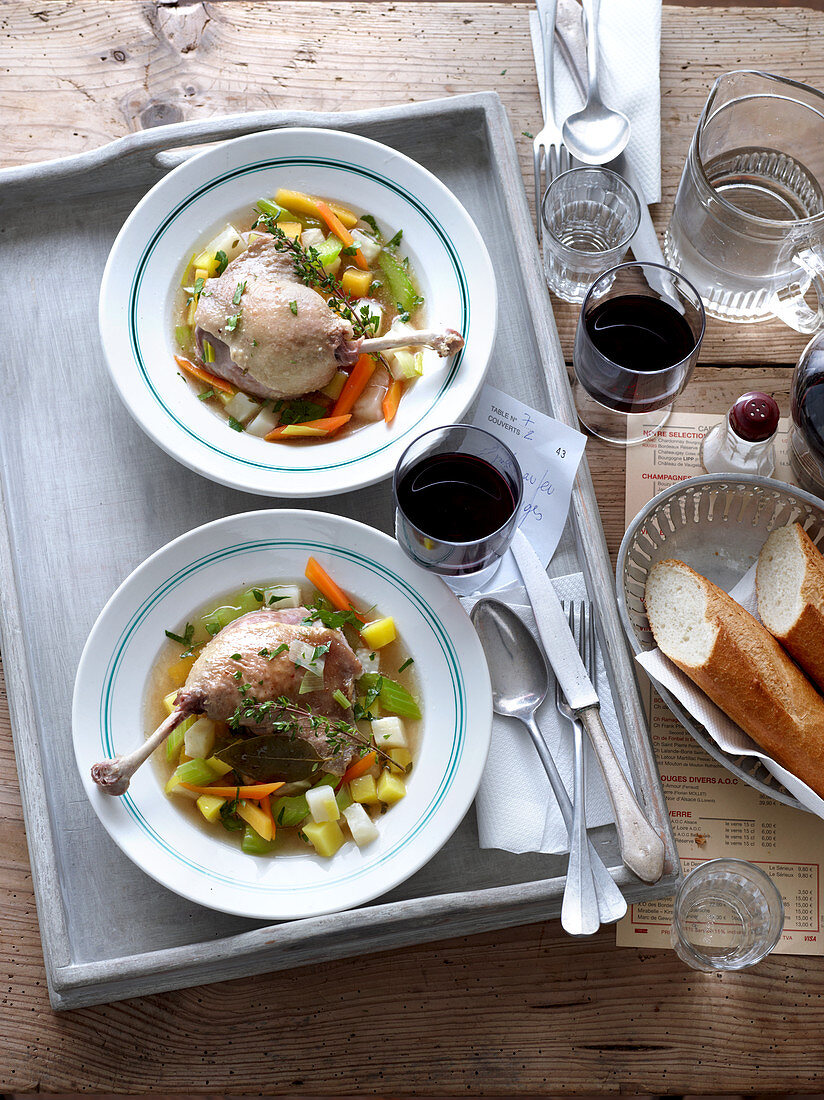 Duck pot au feu served with red wine and bread