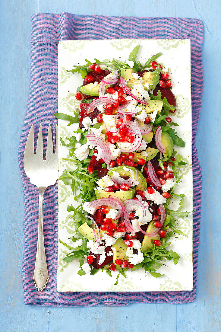 Rocket salad with beetroot, avocado, feta cheese and pomegranate seeds