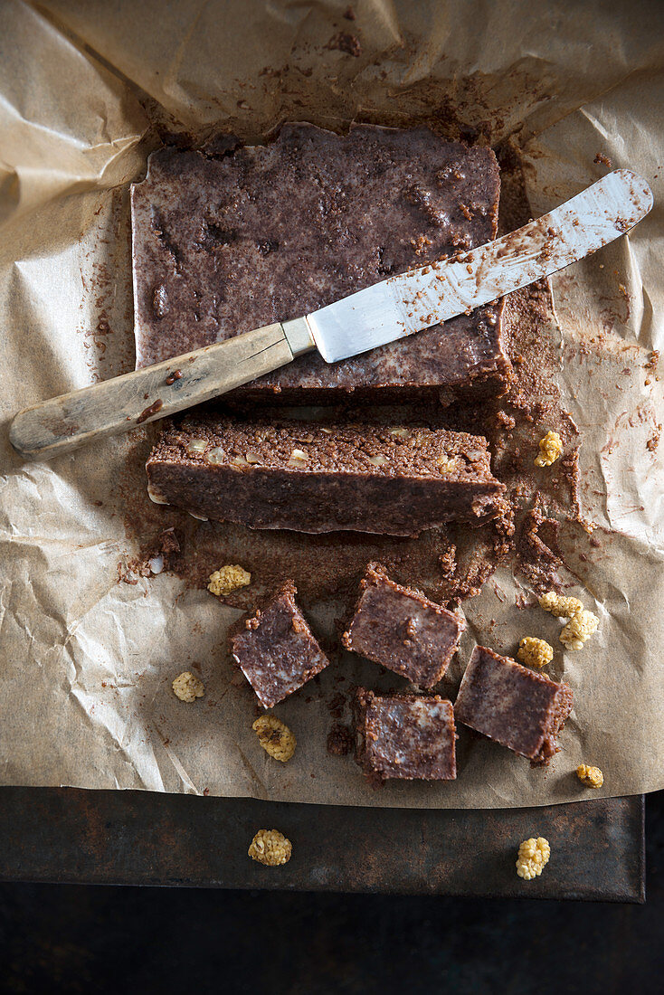 Vegan chocolate made with amaranth and mulberries being sliced