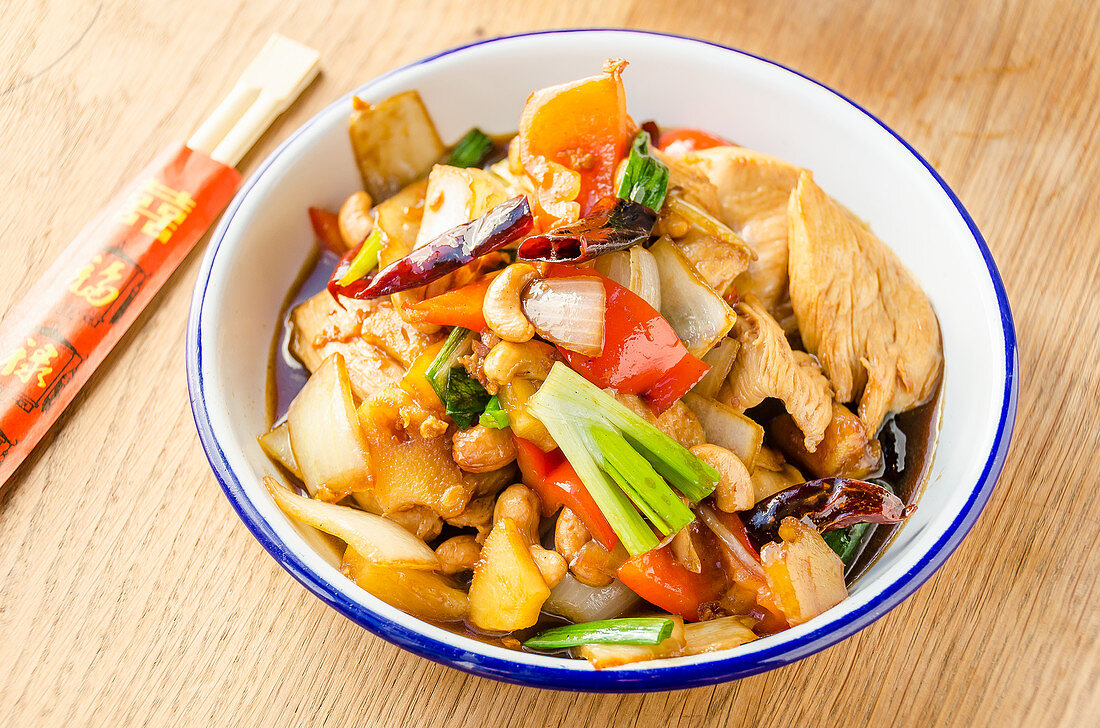 Stir fried chicken with cashew nuts, red peppers, onions, spring onions, pinapple, chilli, carrots in a sweet oyster sauce