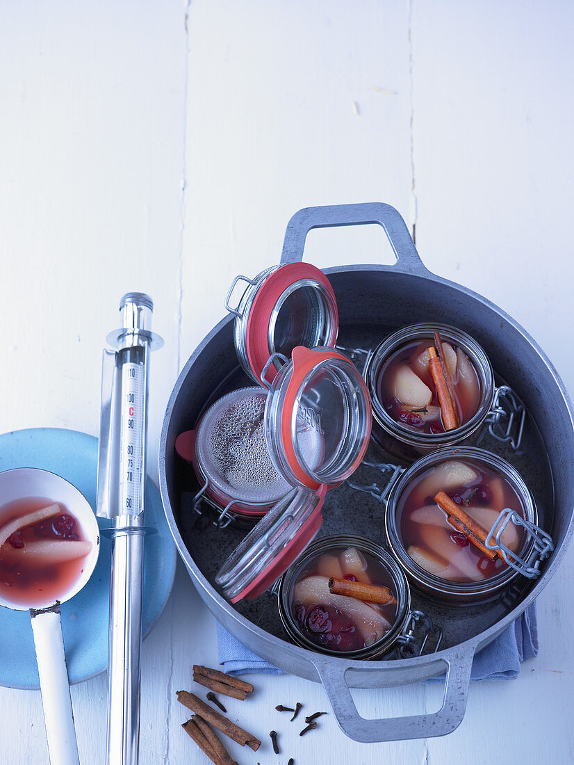 Pear and cranberry compote with cinnamon sticks