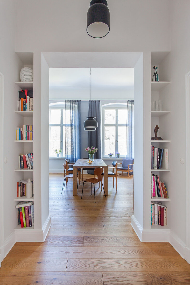 Fitted bookcases flanking doorway leading into dining room