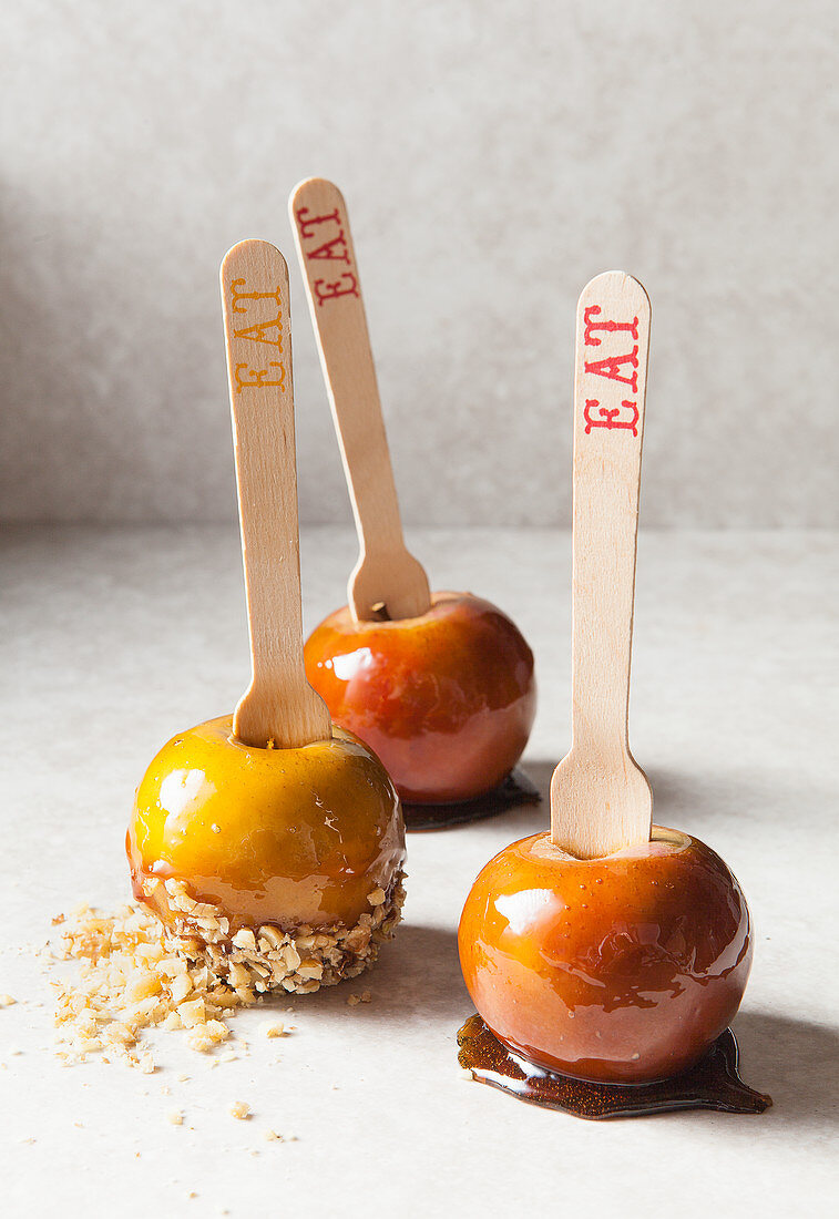 Three toffee apples with almond flakes