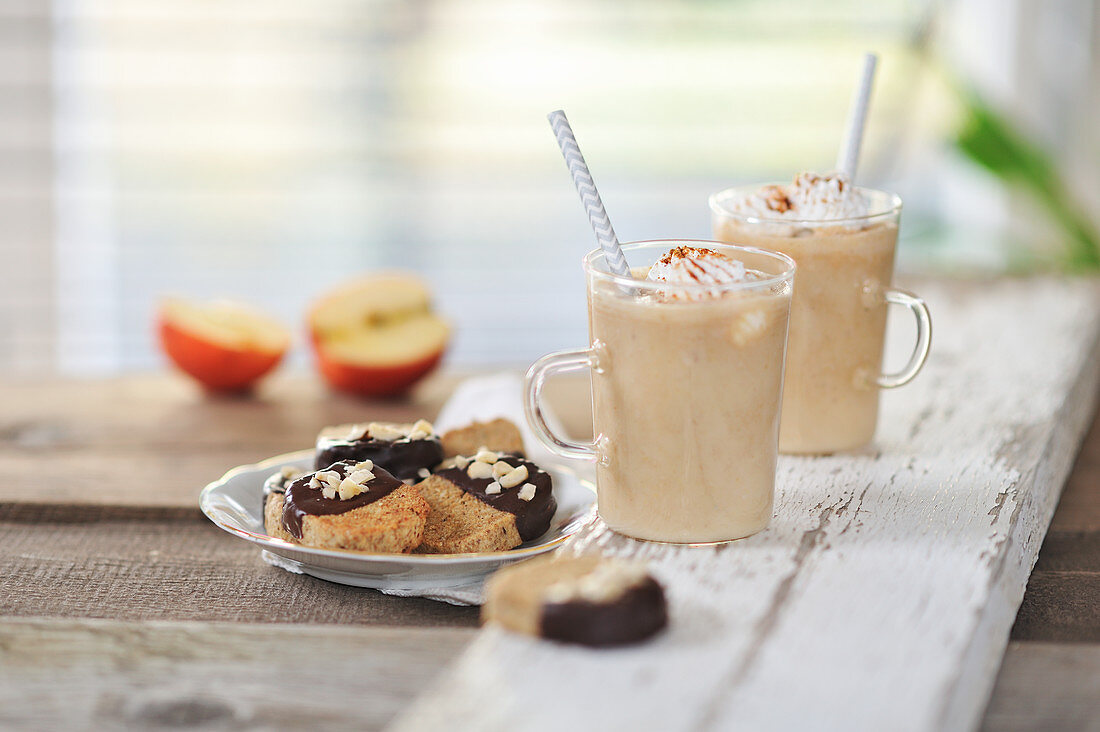 Baked apple smoothies with cream, and hazelnut biscuits with chocolate icing