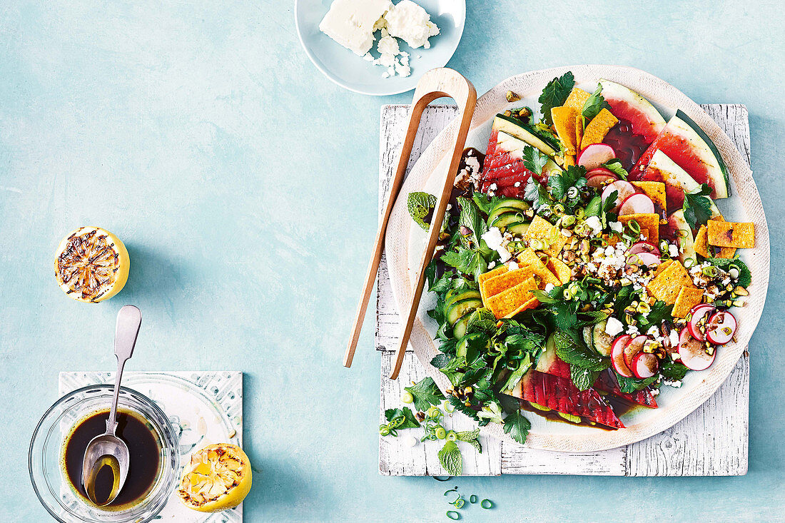A salad with grilled watermelon and pomegranate dressing