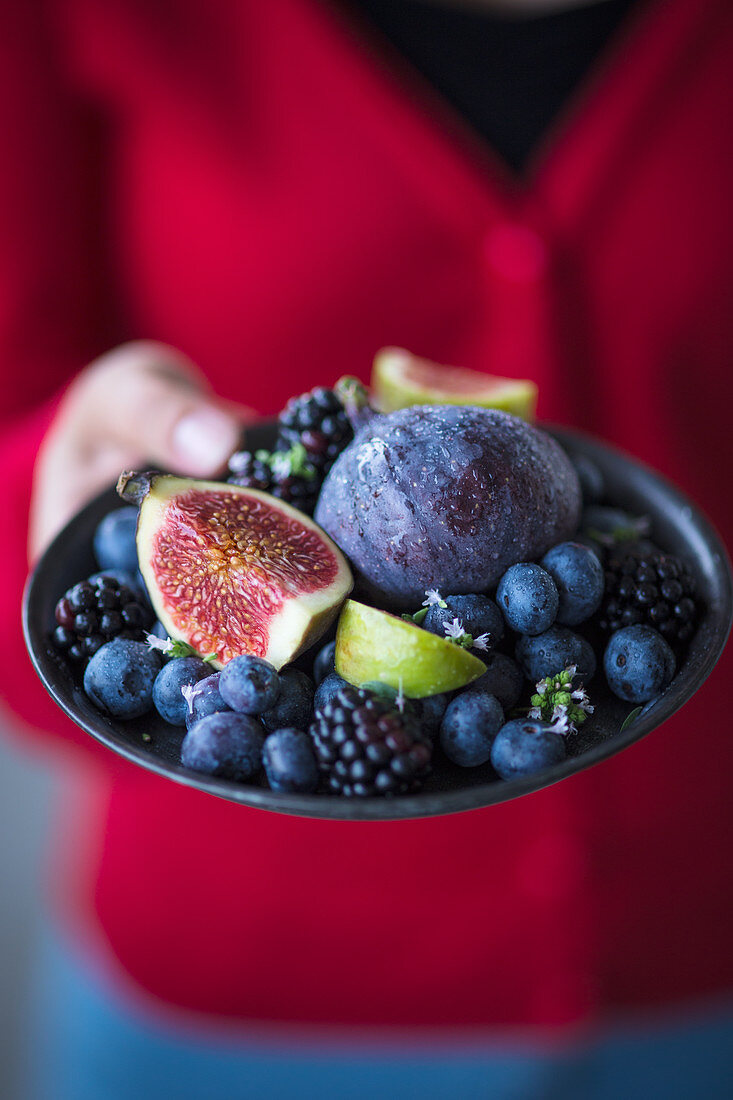 A plate of blackberries, blueberries and figs
