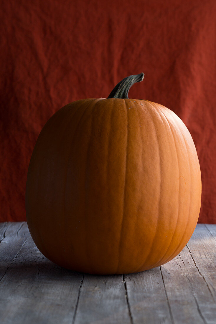 A large halloween pumpkin on a wooden surface