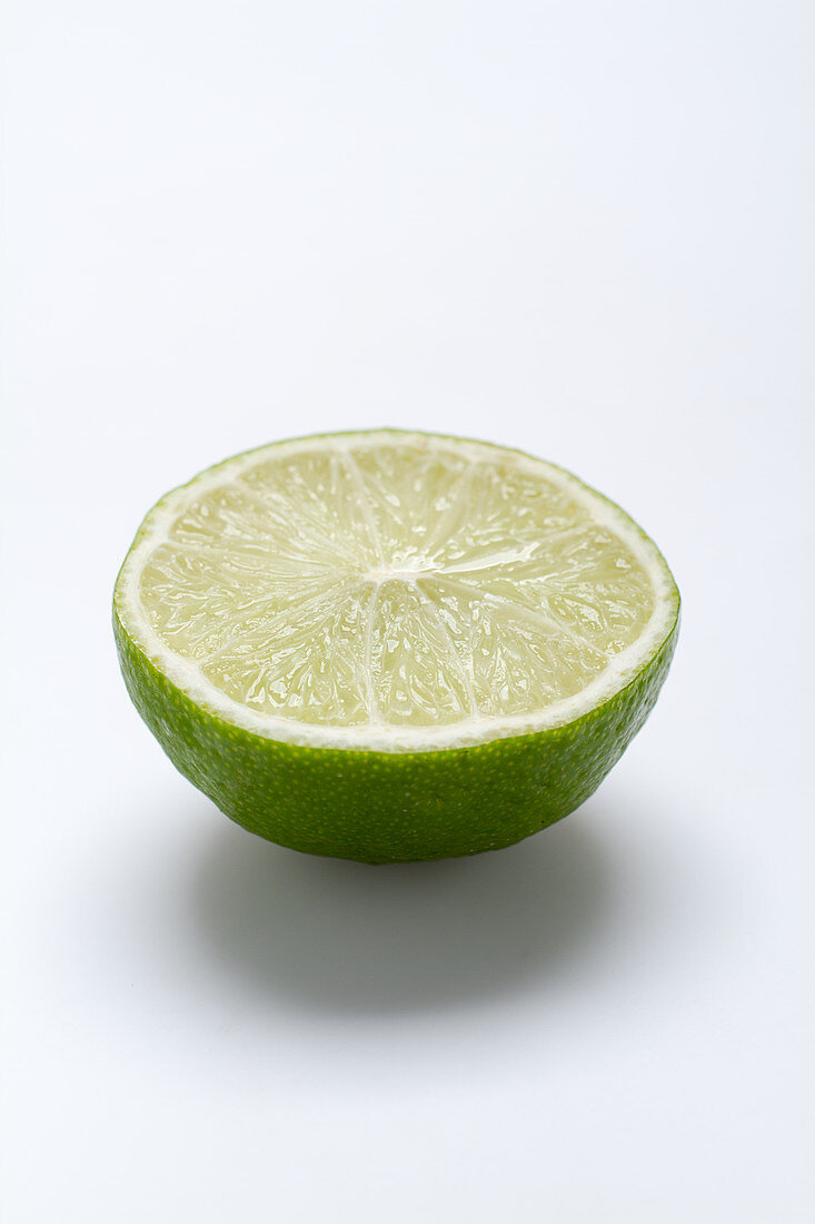 Half a lime on a white surface