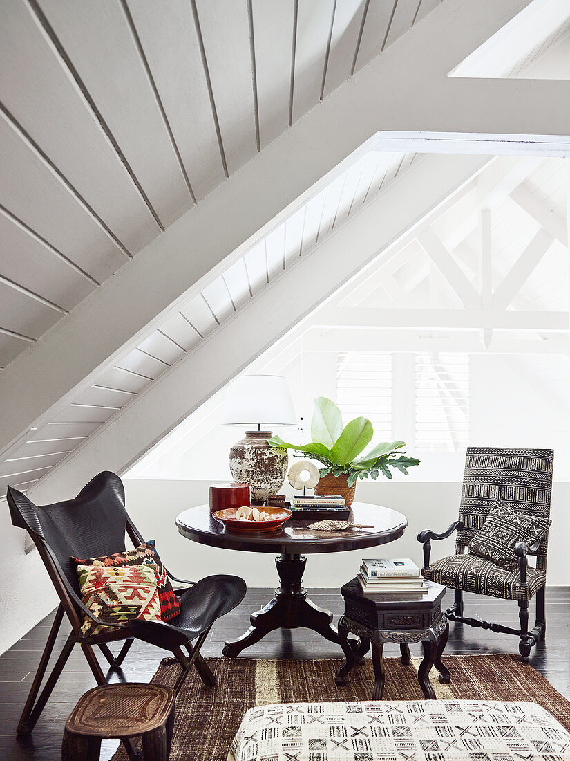 Seat with a round table and two chairs under the roof