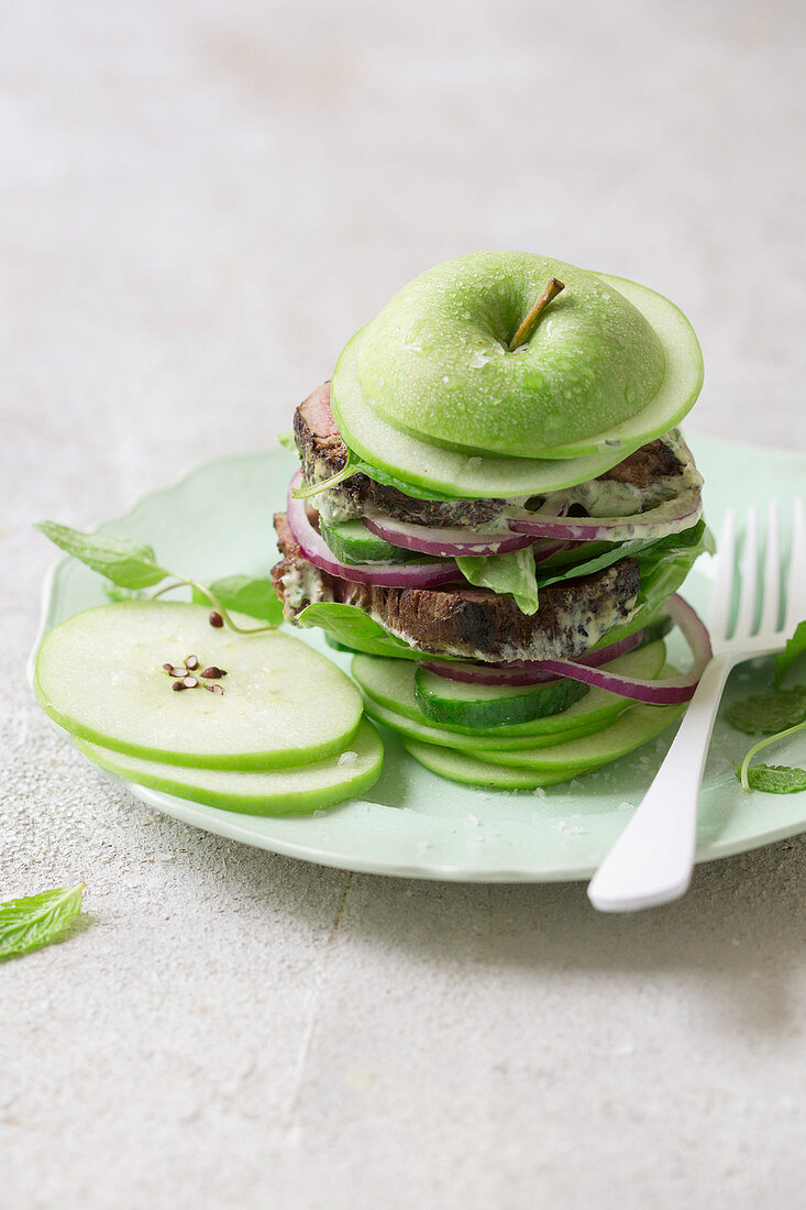 An apple burger with beef fillet and salad