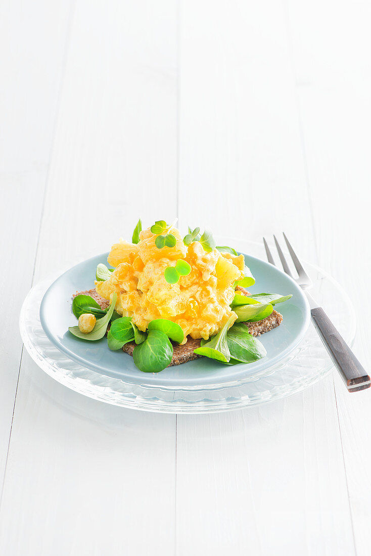 Egg salad with lamb's lettuce on a slice of pumpernickel bread
