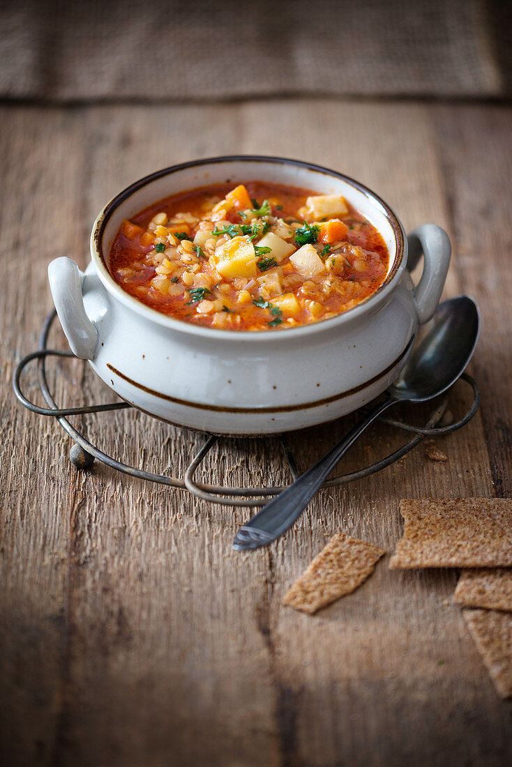 Vegan red lentil soup with potatoes and vegetables