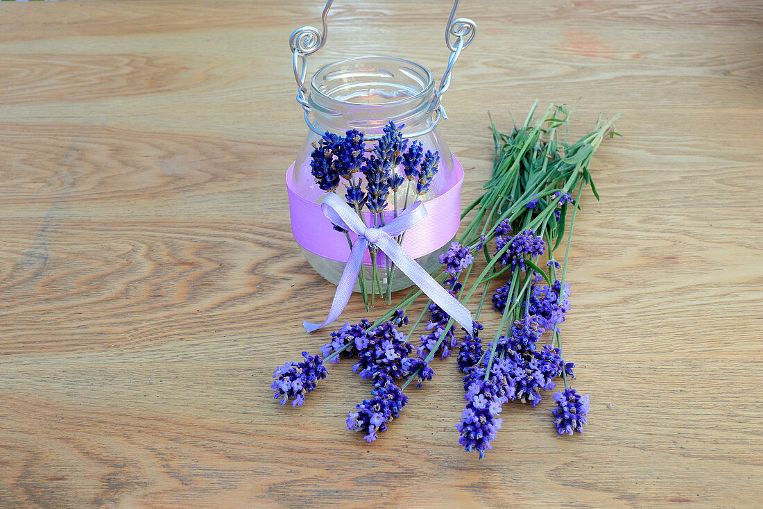 Handmade candle lantern decorated with scented lavender and purple ribbon