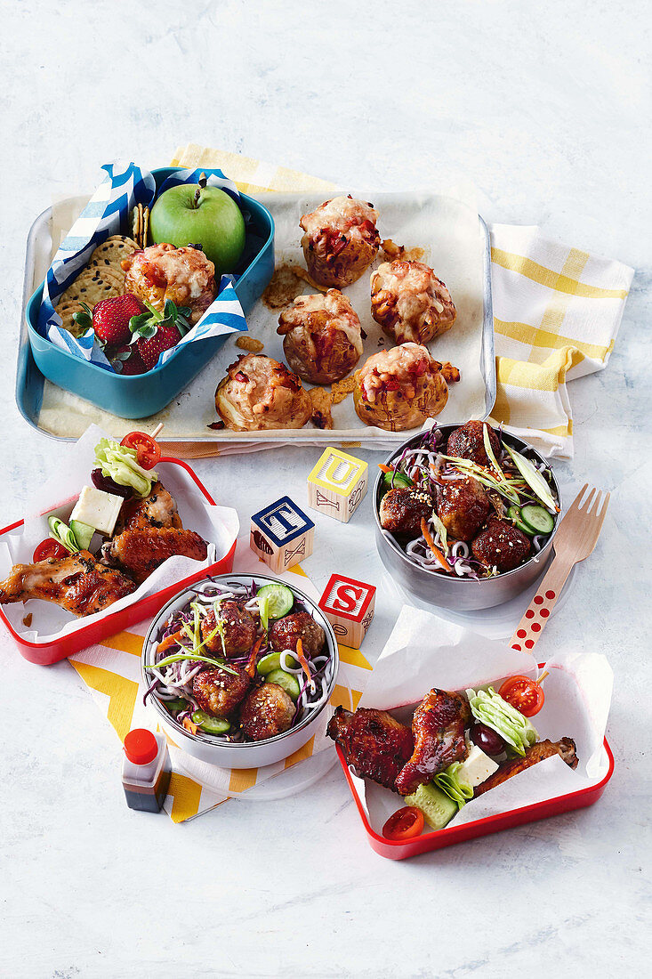 Beany baked potatoes, rainbow noodle salad with meatballs and sticky greek wings