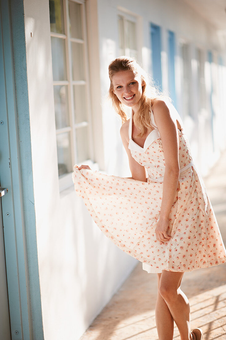 A blonde woman wearing a summer dress