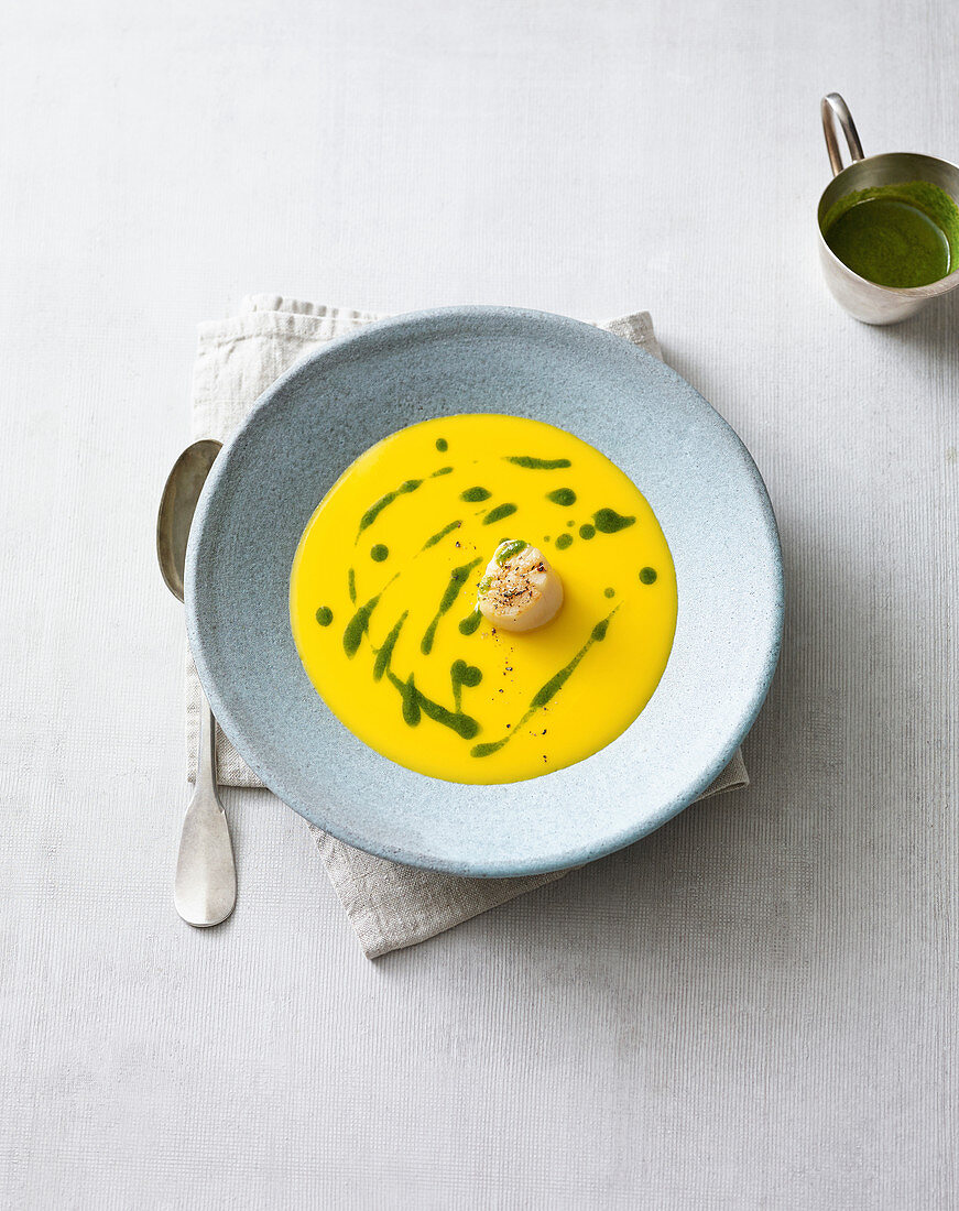 Pumpkin soup with a fried scallop and pesto