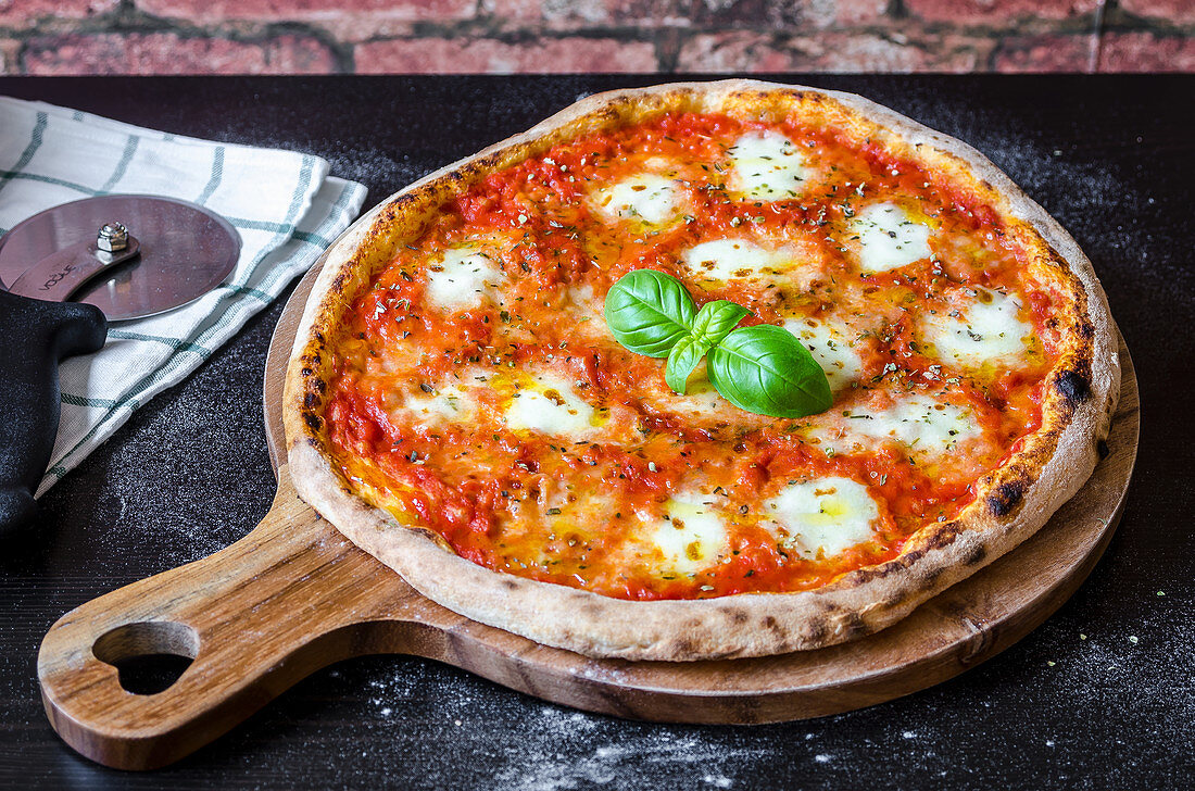 Classic pizza margherita made with a sourdough base, tomato sauce with oregano and olive oil, mozzarella cheese and fresh basil