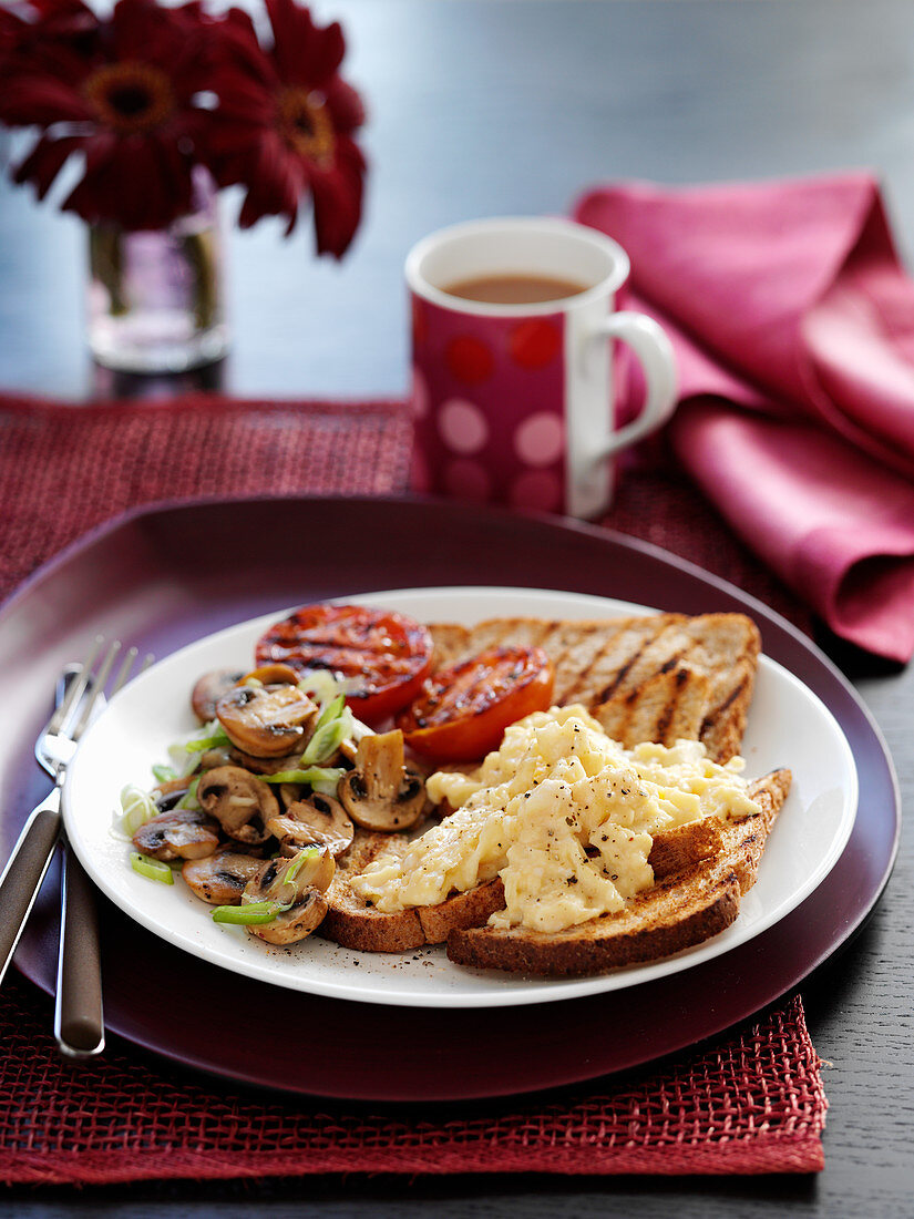 Scrambled Eggs with toast tomatoes and mushrooms