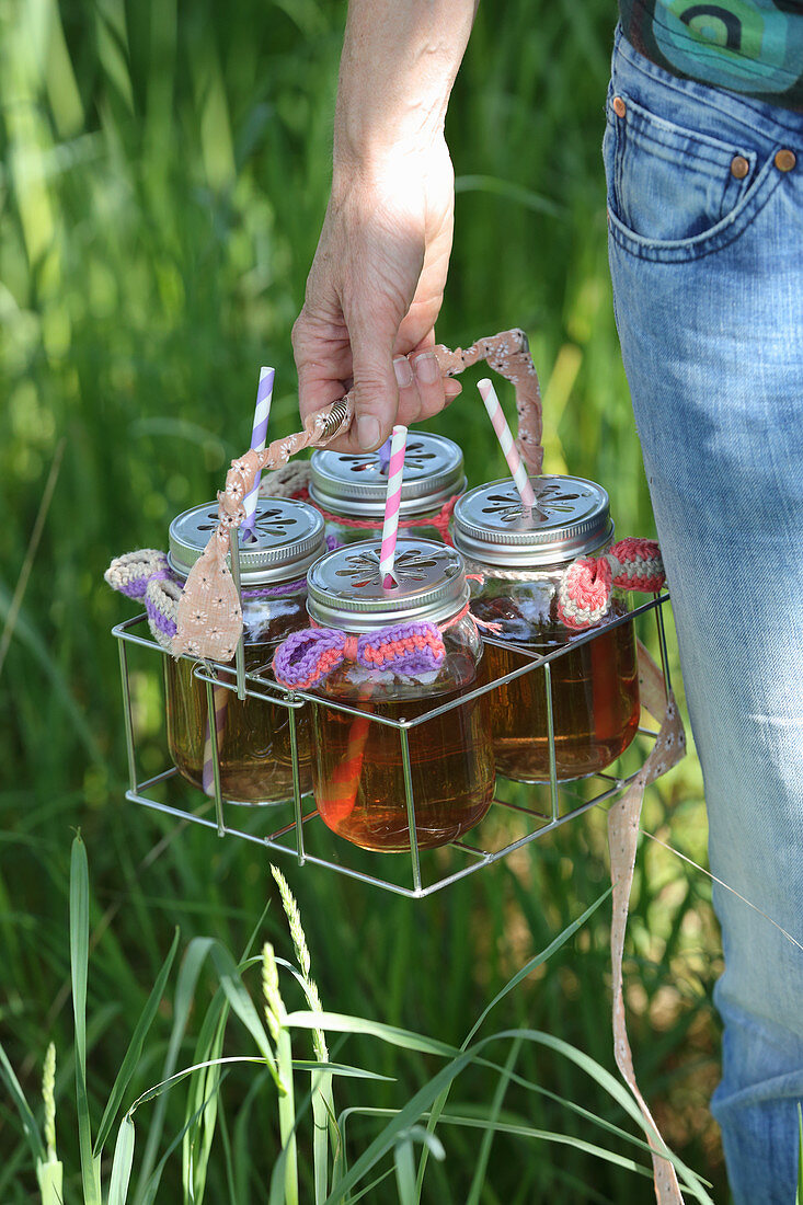 Summer drinks in screw-top jars with crocheted bows