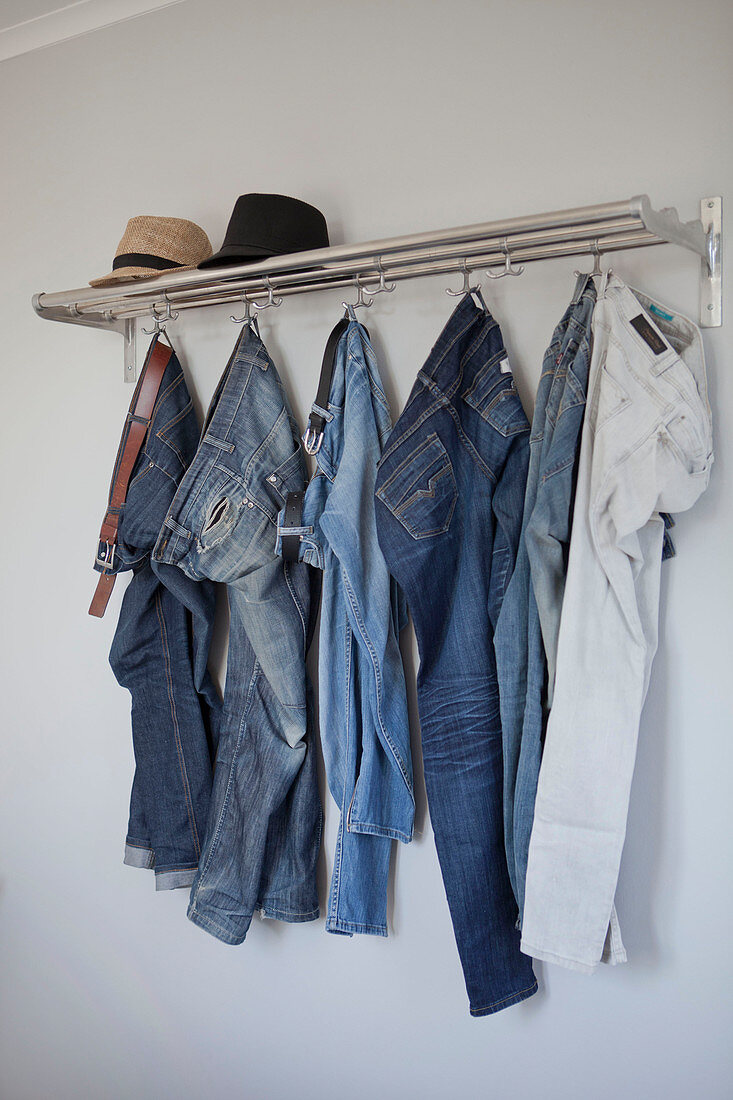 Jeans hung from coat rack