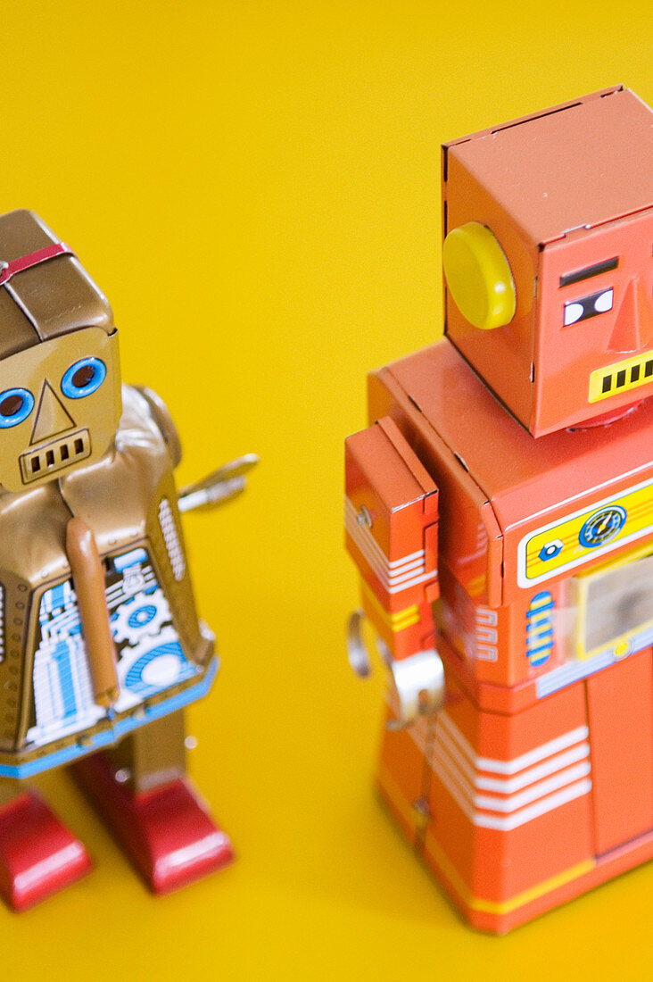 Robot figurines on yellow surface