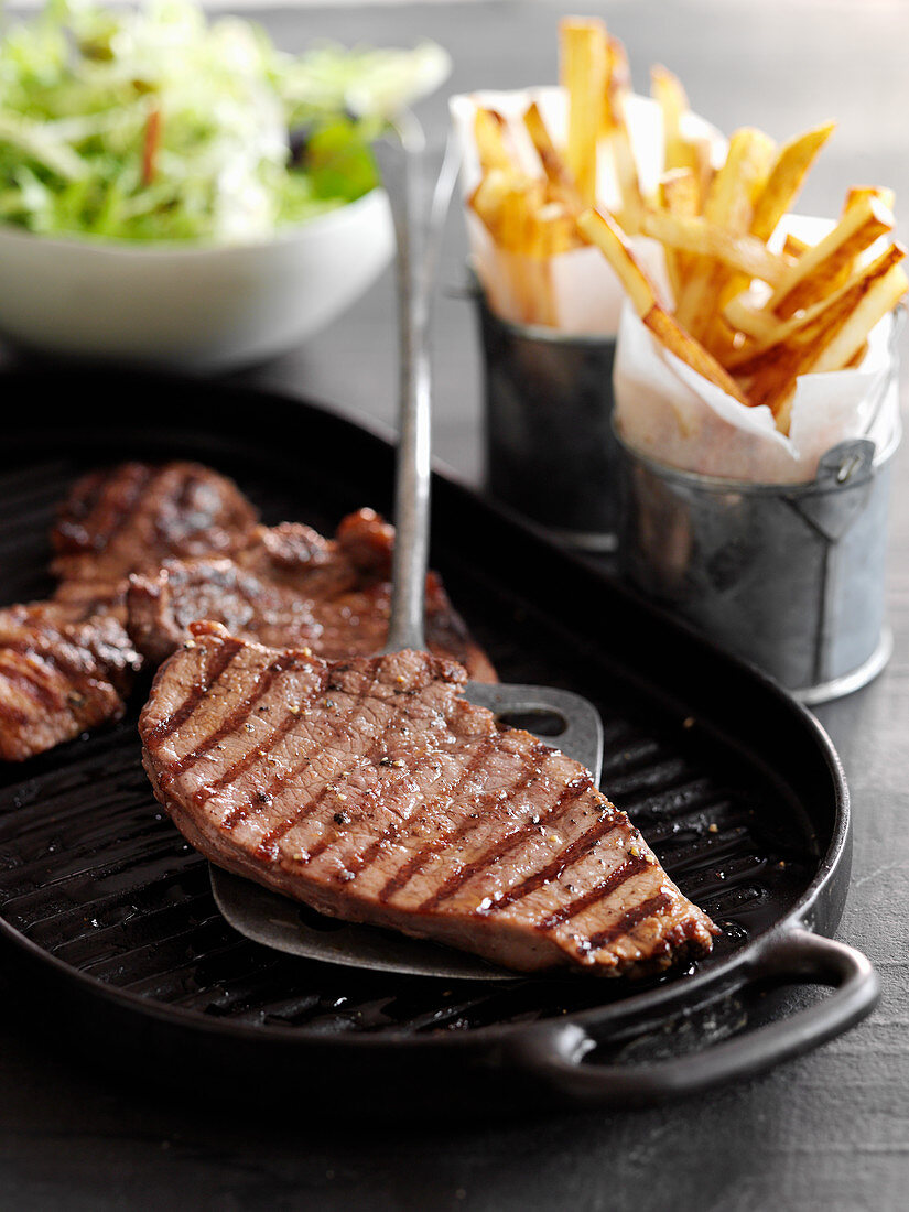 Minute steaks with french fries and salad